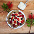 Low carb keto pancakes topped with nuts cream and berries